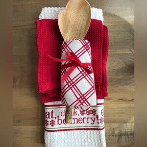 Hallmark hostess gift set consists of three towels and wooden spoon
